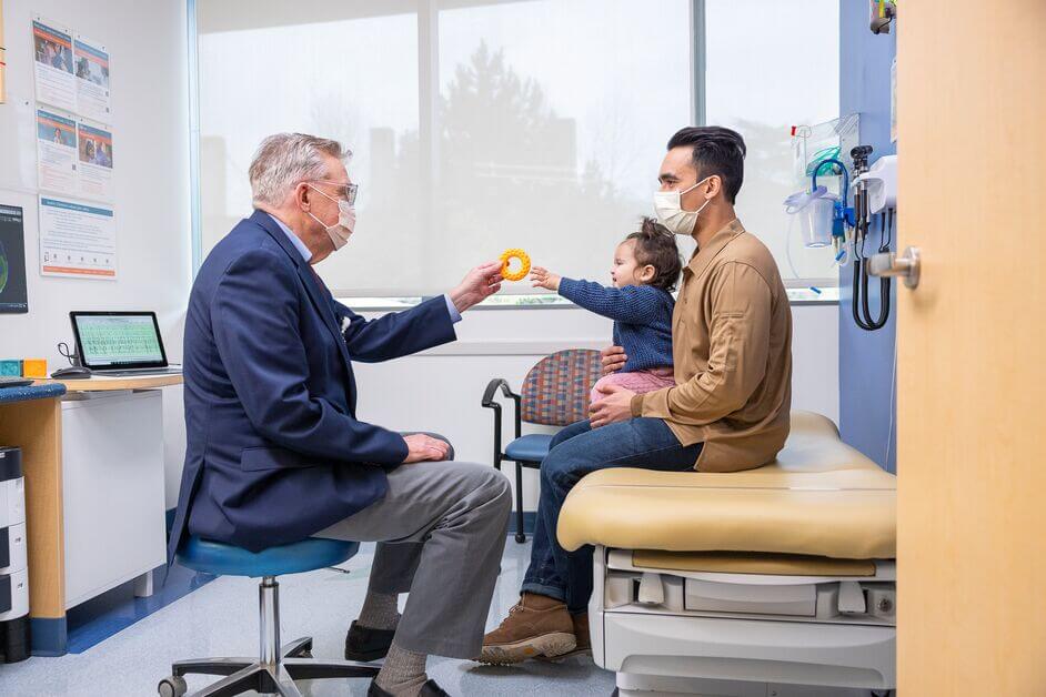 Dr. Edward Novotny showing a toy to a patient