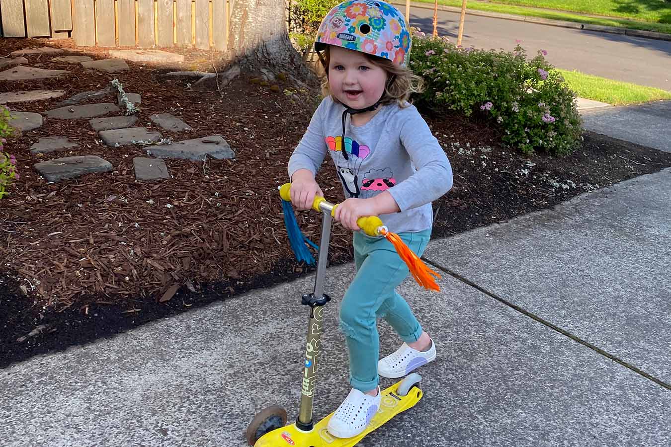 Young girl rides on a scooter