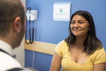 A girl speaking to a doctor