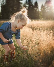 A girl picking flowers in a field