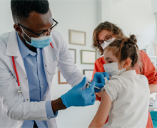 A doctor administering a vaccination to a child.