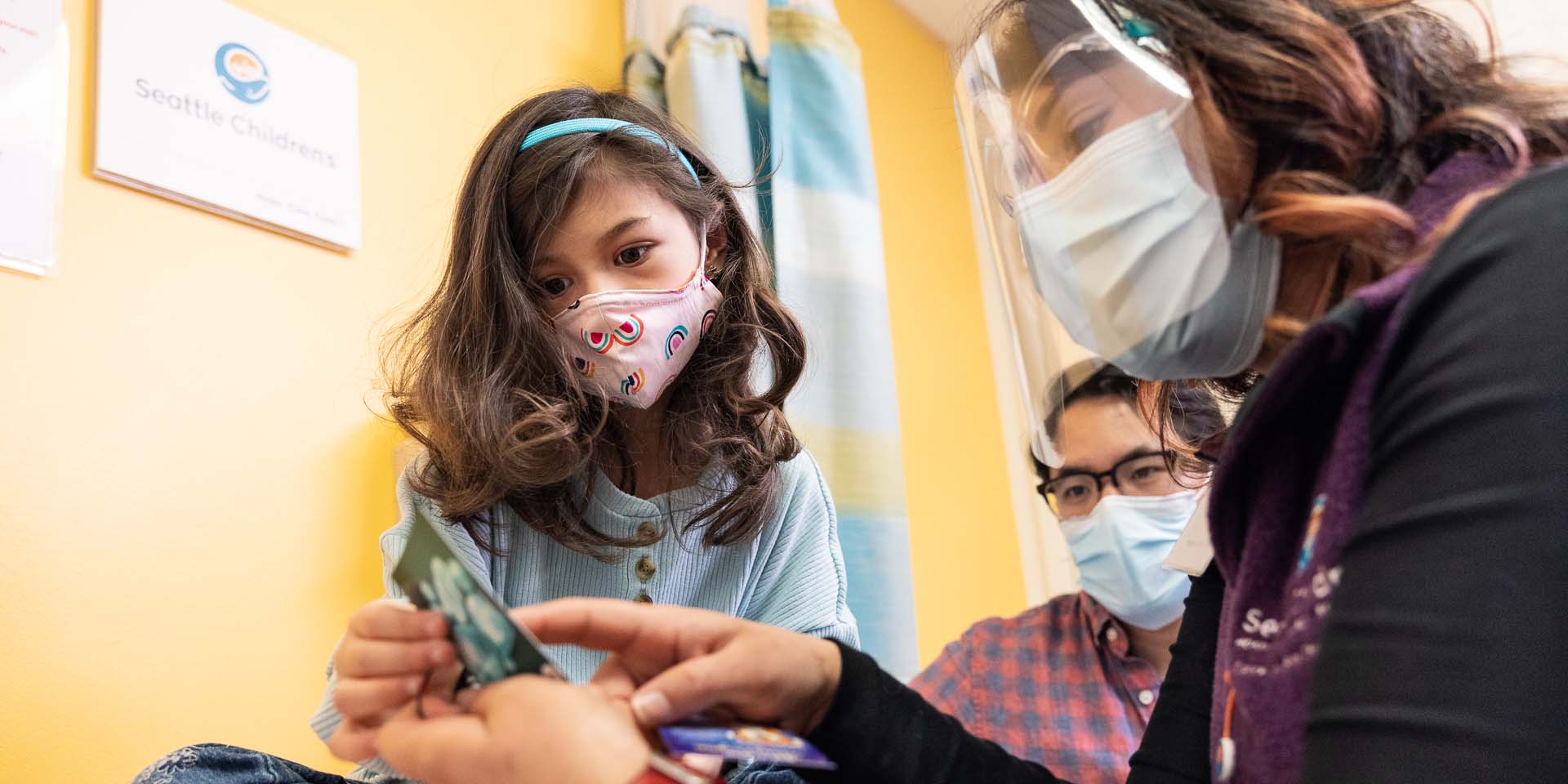 A girl looks at information ahead of her hospital stay