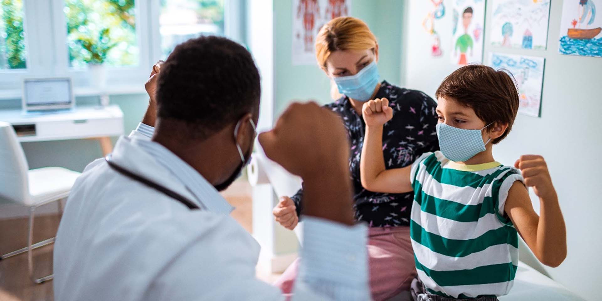 patient posing with provider and caregiver